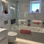 marble bathroom with tv install