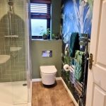 bathroom install with leave wallpaper